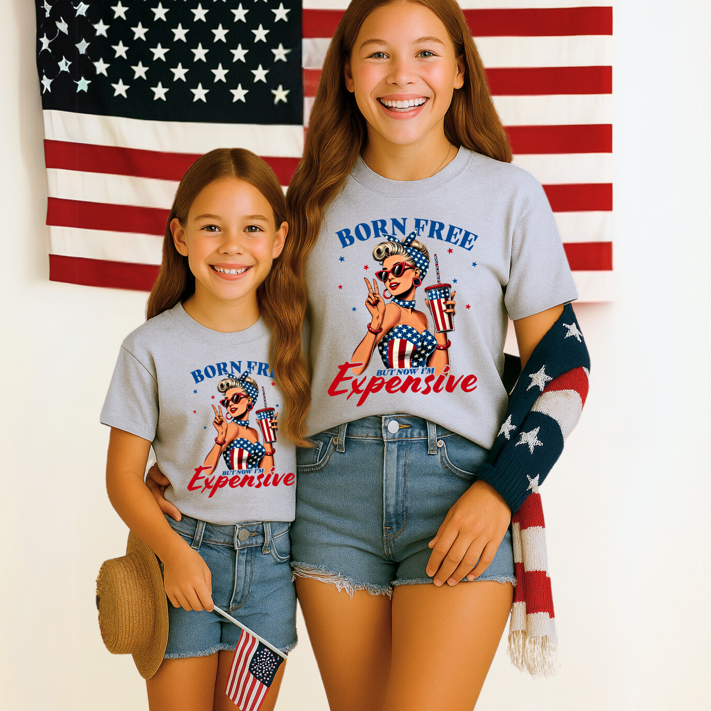 Girls in Gray shirt with retro patriotic graphic that says “Born Free But Now I’m Expensive”

