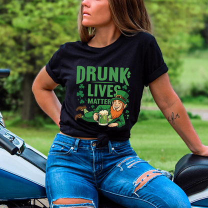 Woman wearing a black t-shirt featuring a relaxed leprechaun holding a beer mug, with 'Drunk Lives Matter' text and shamrock decorations