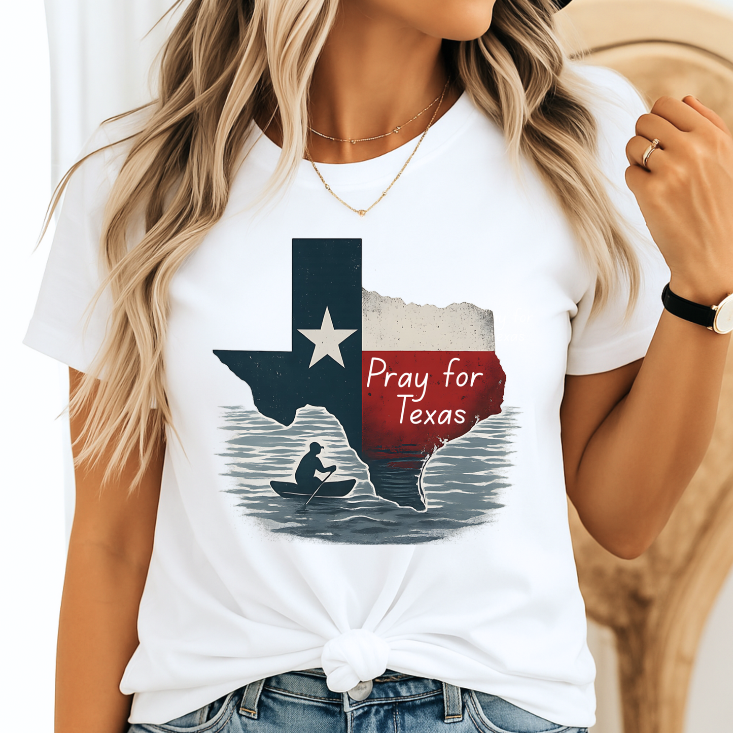 White unisex Pray for Texas T-shirt featuring a distressed Texas flag graphic with "Pray for Texas" text and a silhouette of a person in a canoe. Casual women's outfit paired with denim, perfect for Texas pride and support.