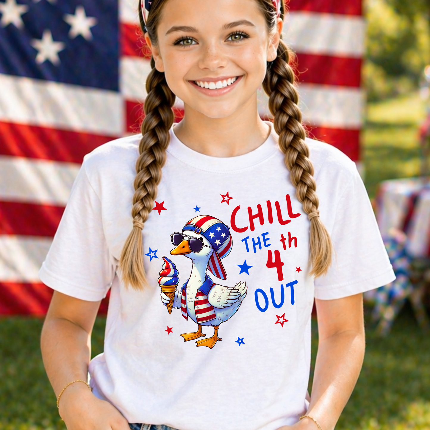 Girl wearing pink patriotic goose shirt with denim shorts and outdoor summer background